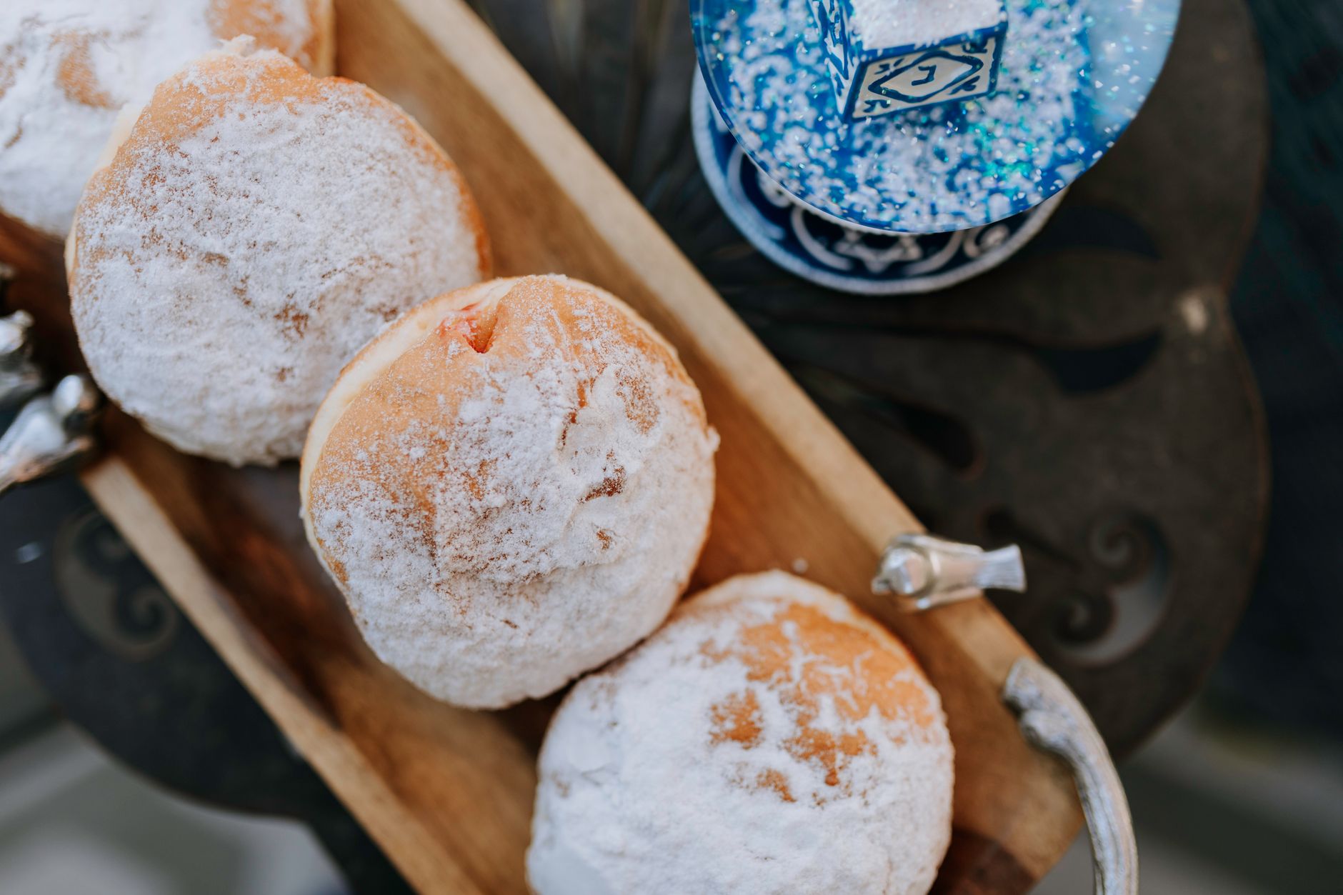 Close-up of traditional sufganiyot and dreidel, perfect for Hanukkah celebrations.