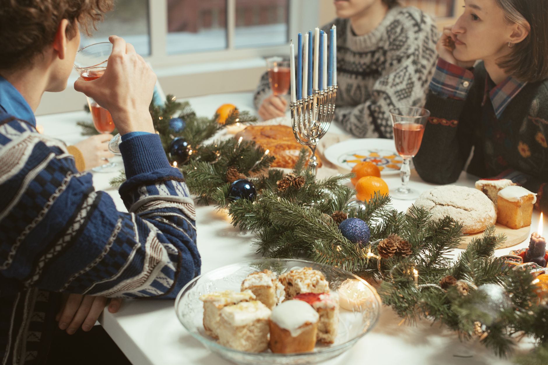 Cozy Hanukkah gathering with traditional food and festive décor creating a warm atmosphere.
